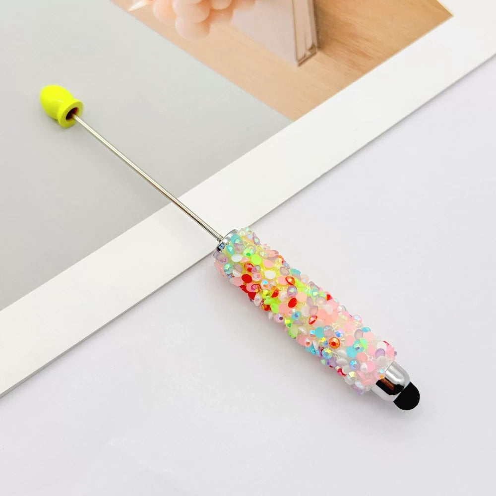 Set of 11 glitter rhinestone beadable pens in assorted colors including white, hot pink, black, multicolor, pink, light pink, teal, brown, purple, blue, and lavender, displayed on a white surface. - 1