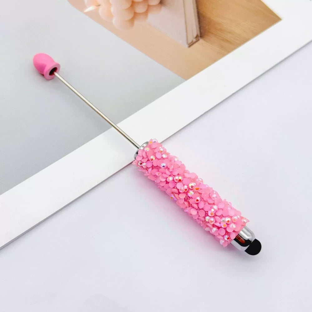 Set of 11 glitter rhinestone beadable pens in assorted colors including white, hot pink, black, multicolor, pink, light pink, teal, brown, purple, blue, and lavender, displayed on a white surface. - 4