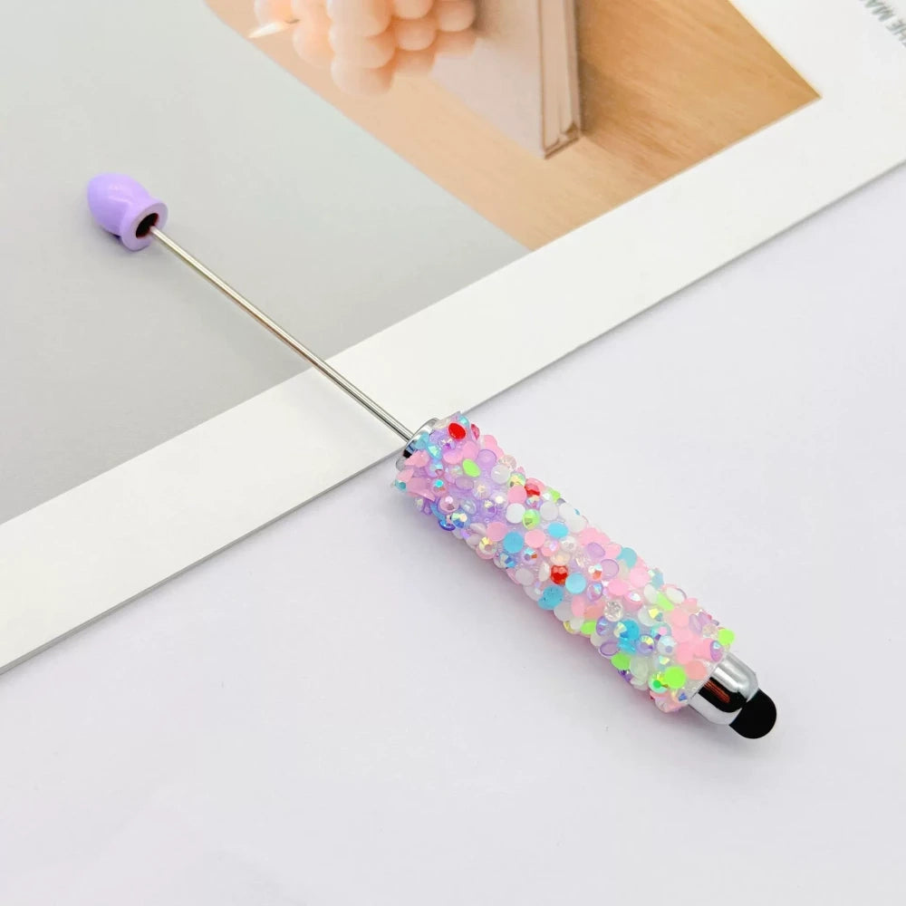 Set of 11 glitter rhinestone beadable pens in assorted colors including white, hot pink, black, multicolor, pink, light pink, teal, brown, purple, blue, and lavender, displayed on a white surface. - 6