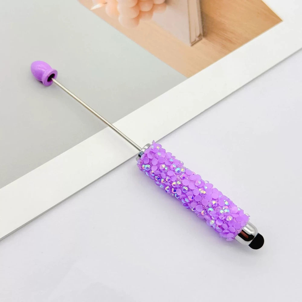 Set of 11 glitter rhinestone beadable pens in assorted colors including white, hot pink, black, multicolor, pink, light pink, teal, brown, purple, blue, and lavender, displayed on a white surface. - 8