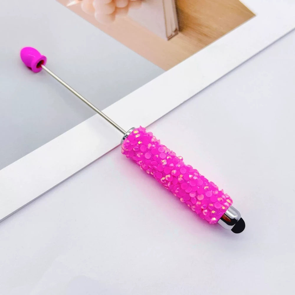 Set of 11 glitter rhinestone beadable pens in assorted colors including white, hot pink, black, multicolor, pink, light pink, teal, brown, purple, blue, and lavender, displayed on a white surface. - 9