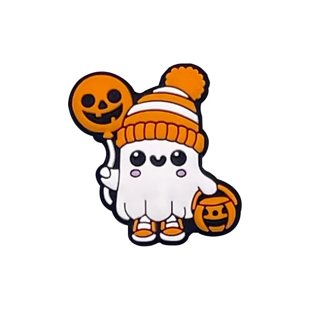 Cute Halloween silicone focal beads featuring ghost characters in orange knit hats with pumpkin balloons and shark characters in purple witch hats with jack-o-lantern accents, displayed on a miniature white bench. - Ghost
