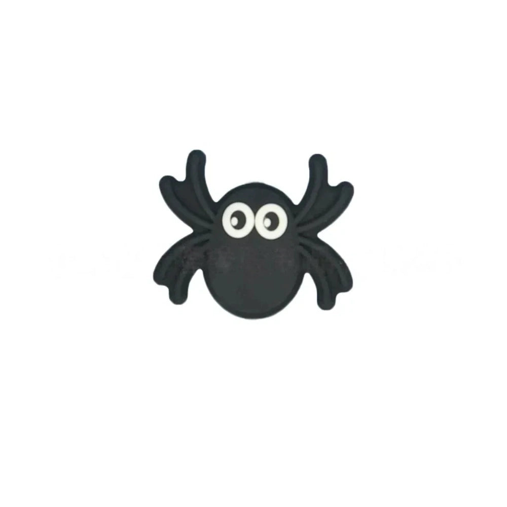 Set of 5 Halloween silicone focal beads including a BOO pumpkin, haunted house, black spider, and two bats displayed on a miniature white bench - Spider