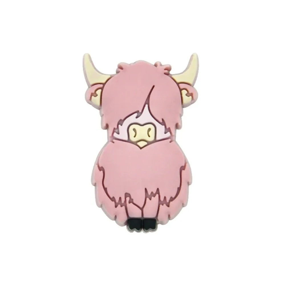 Eight colorful silicone highland cow focal beads in pink, mauve, yellow, cream, grey, brown, dark brown, and purple displayed on a miniature white wooden bench against a teal background. - 4