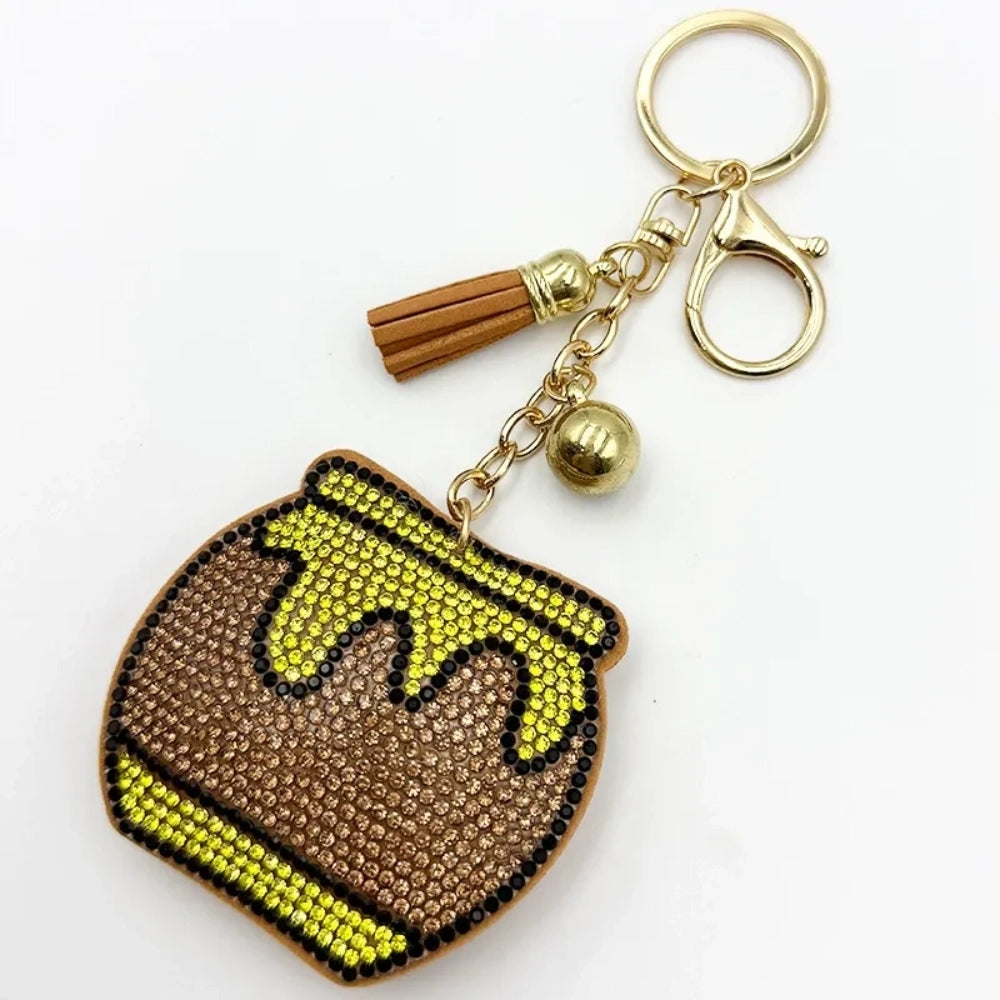 Rhinestone honey pot jar bead charm keychain with yellow and brown crystals, gold lobster clasp, tassel, and bell accent for DIY jewelry making.