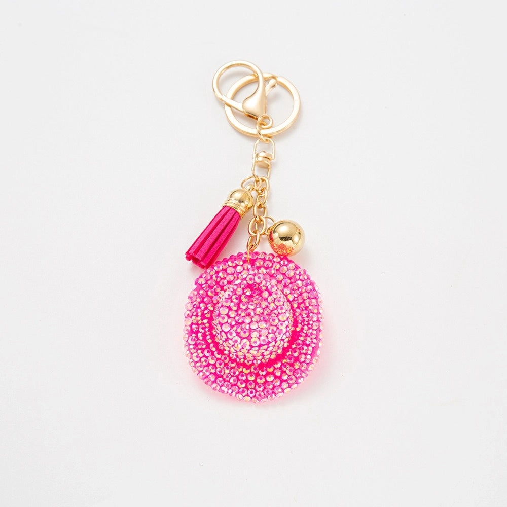 Hot pink AB rhinestone-encrusted rose flower keychain charm with gold lobster clasp, pink tassel, and gold ball accent on white background