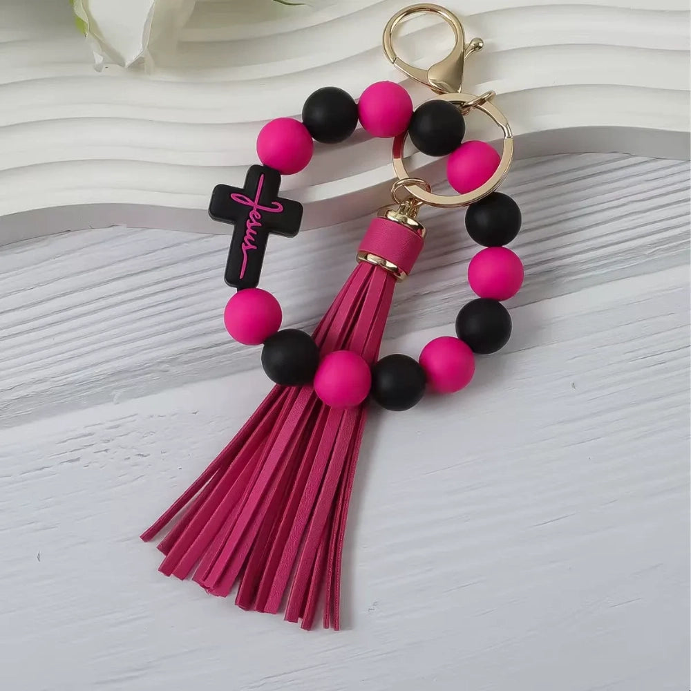 Colorful Jesus cross silicone bead stretch bracelets with tassel keychains in black, pink, purple, teal, and green color combinations on white background. - Rose Red