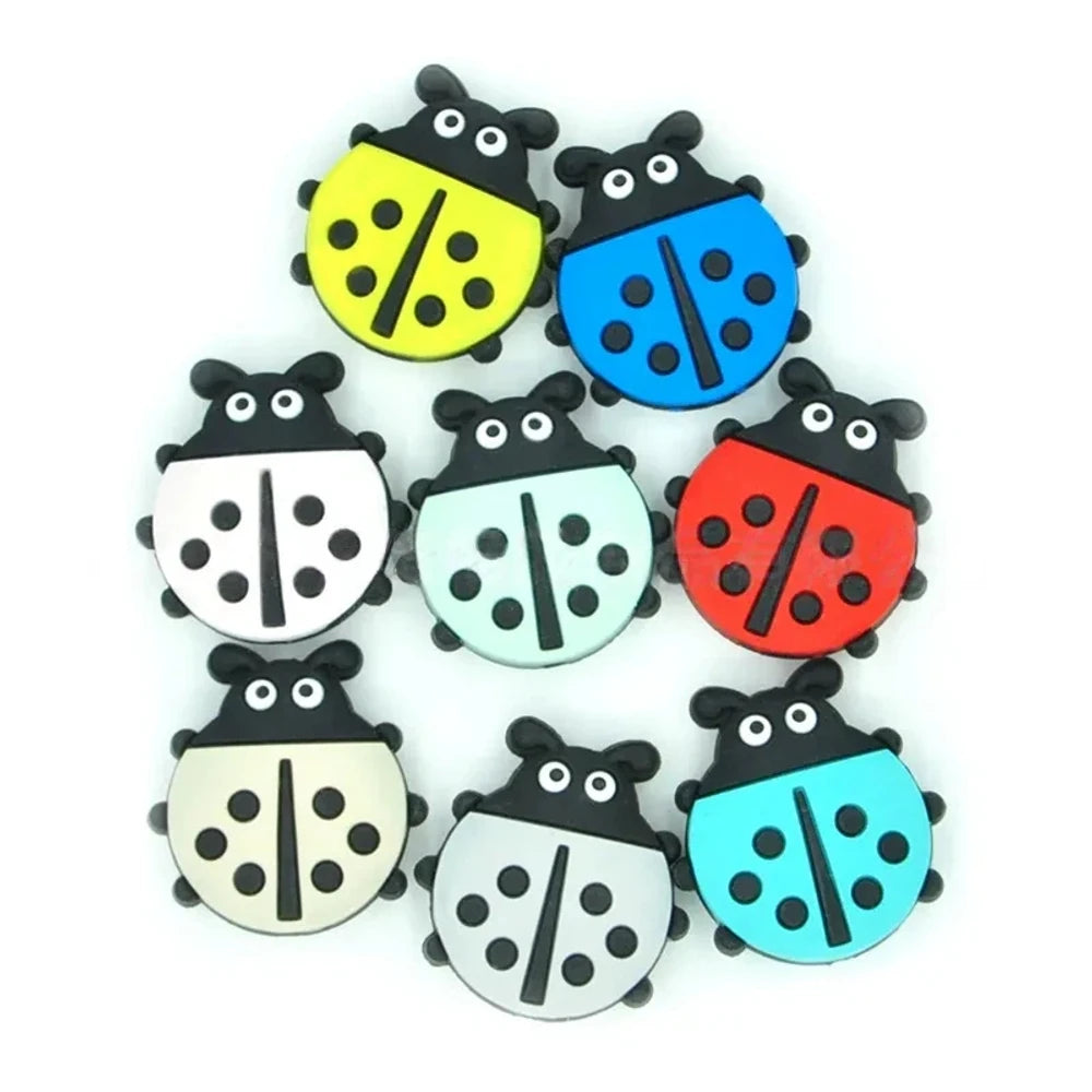 Eight colorful ladybug silicone focal beads in yellow, blue, white, mint, red, cream, gray, and teal with black spots and cartoon faces, used for beadable pens, keychains, and badge reels.