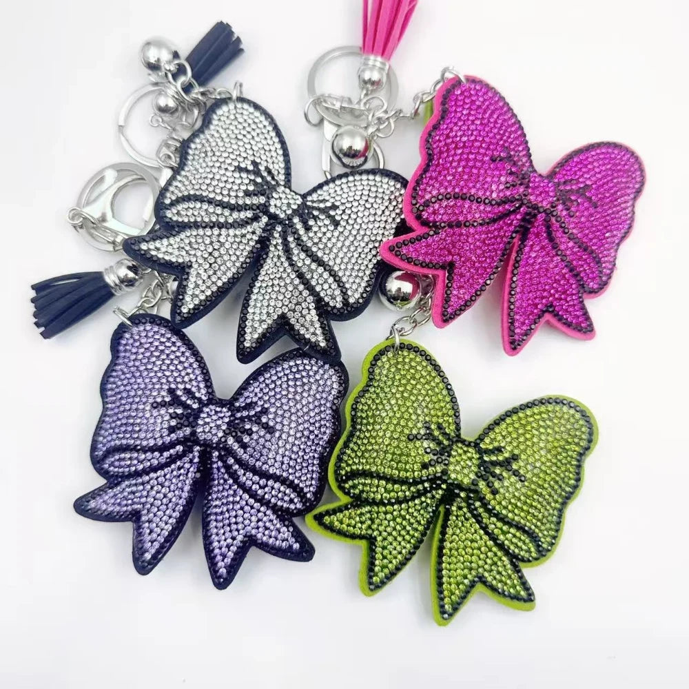 Large bow-shaped rhinestone fancy beads in silver, hot pink, lavender, and lime green on a white background.