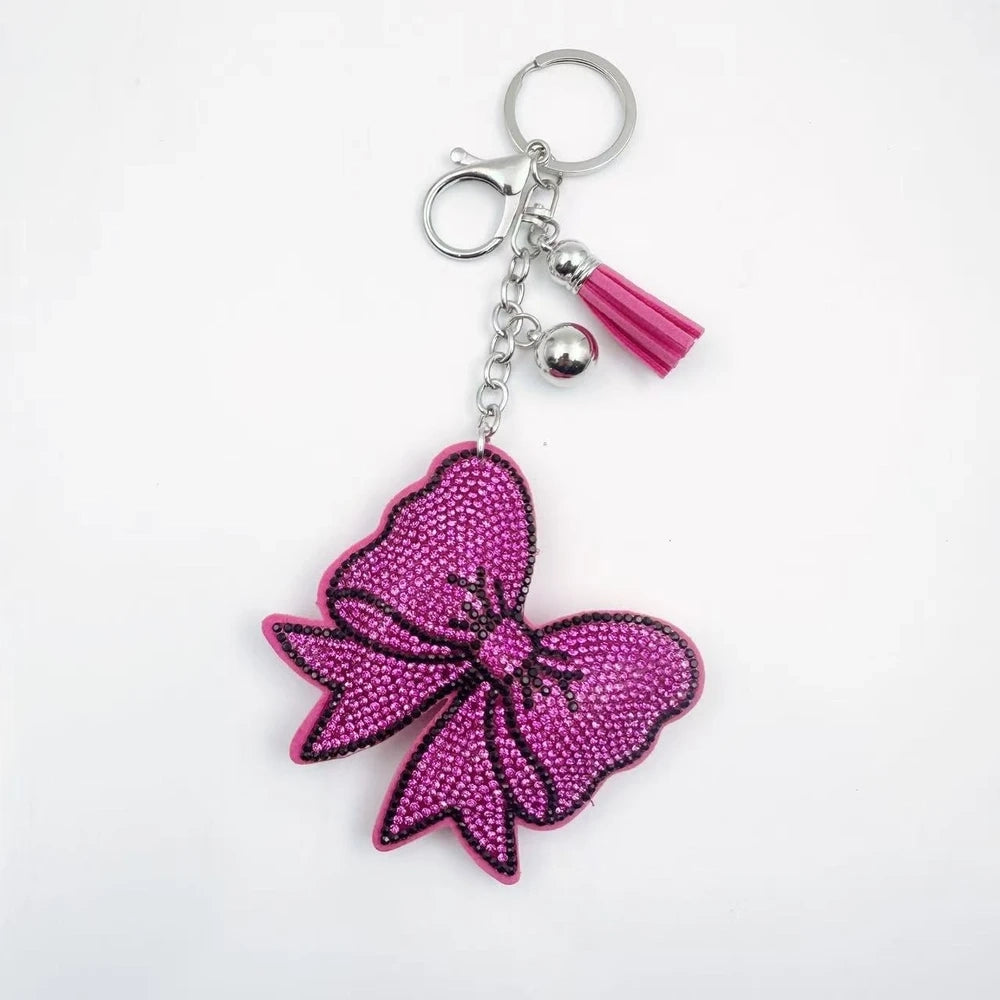 Large bow-shaped rhinestone fancy beads in silver, hot pink, lavender, and lime green on a white background. - Red