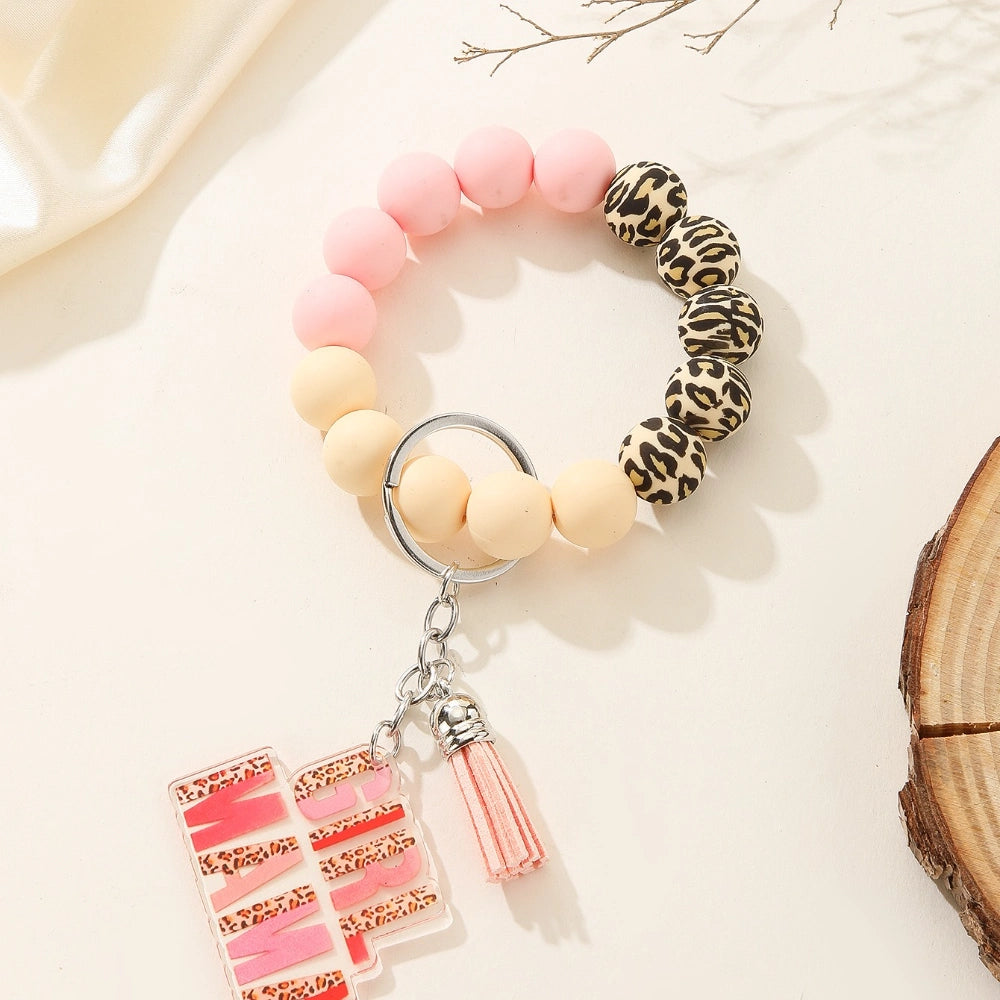 Colorful leopard print and solid silicone beaded bracelet keychains with Girl Mama and Boy Mama acrylic charms in pink and blue color schemes - 1