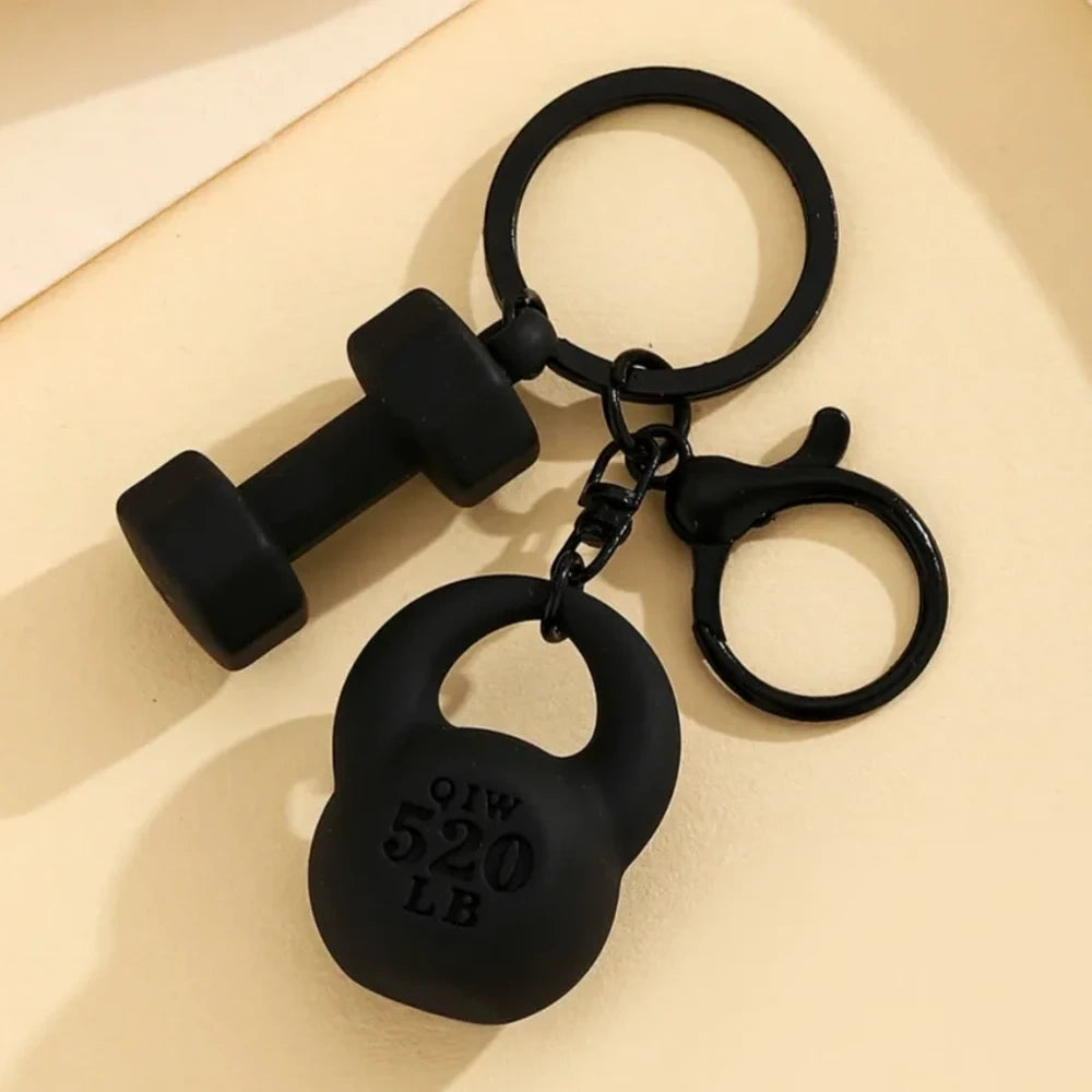 Set of colorful mini dumbbell and kettlebell keychain charms in red, pink, white, blue, black, purple, hot pink, and green, featuring 520 LB design, displayed on a yellow background. - Black