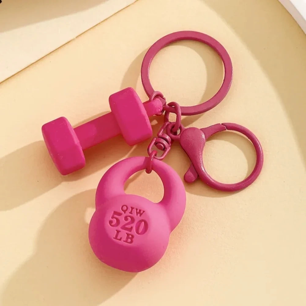 Set of colorful mini dumbbell and kettlebell keychain charms in red, pink, white, blue, black, purple, hot pink, and green, featuring 520 LB design, displayed on a yellow background. - Rose Red