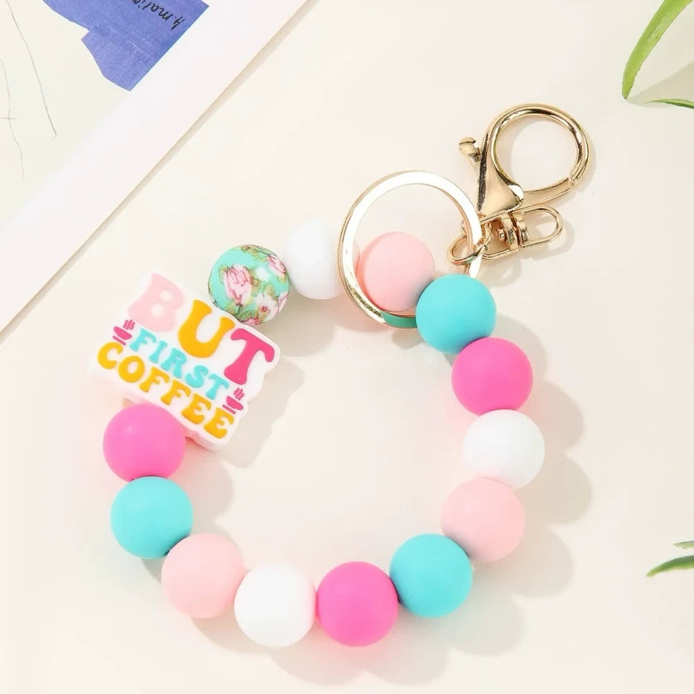 Colorful motivational quote printed silicone beads in pink, orange, teal, yellow and white used on beaded keychain bracelets with gold lobster clasp hardware - Pink