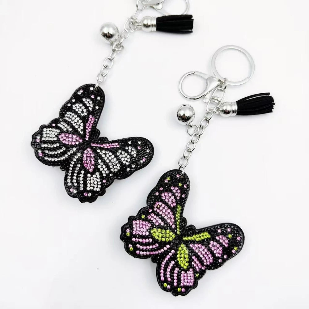 Two butterfly rhinestone fancy bead charms with black backing, pink accents, silver hardware, and tassels on a white background. - Random Mixed