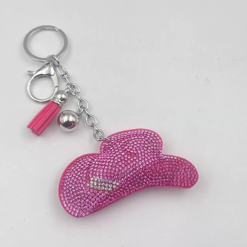 Pink and gold rhinestone cowboy hat fancy bead charms with tassels and key rings on a white background - Pink