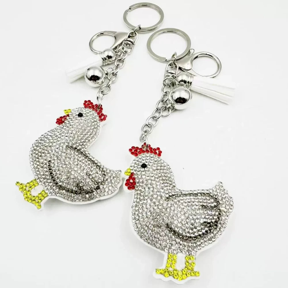Two white hen rhinestone fancy bead charms with silver keychain rings and tassel accents on white background - Random Mixed