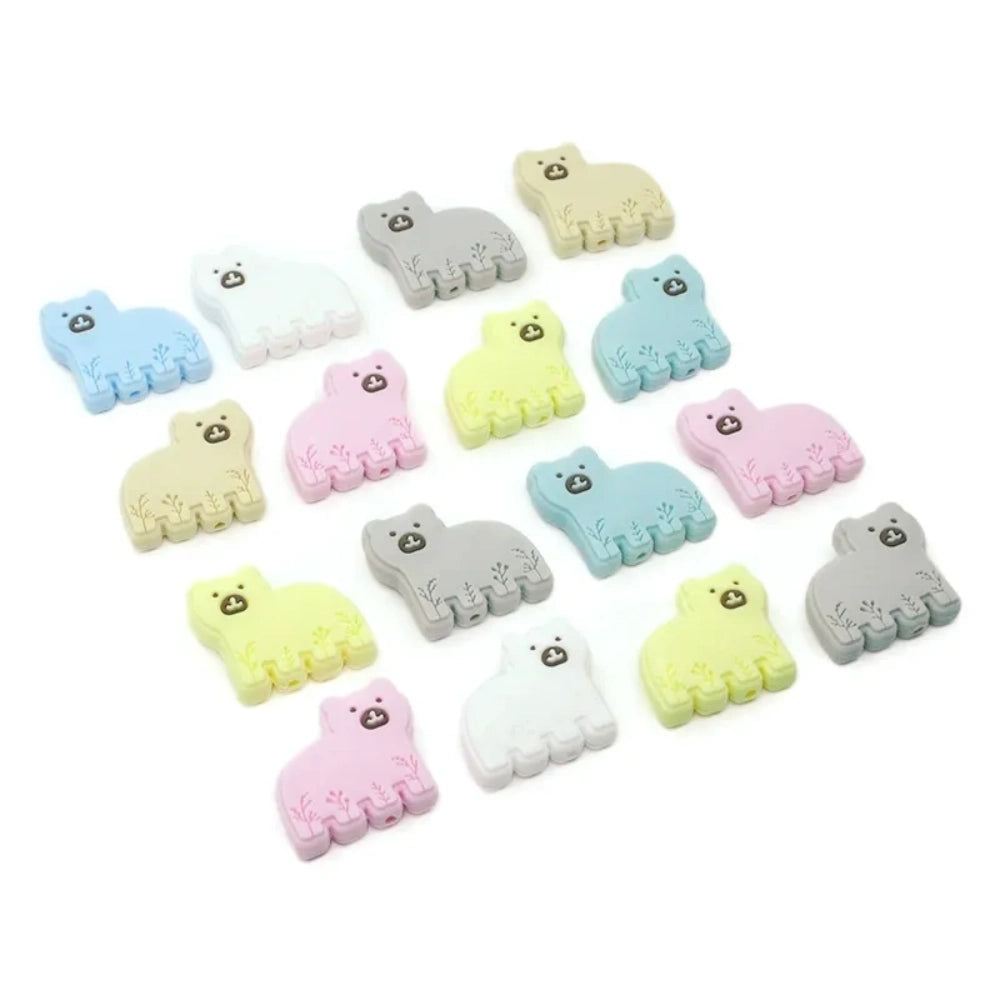 Assorted pastel silicone bear focal beads in blue, pink, white, yellow, gray, and tan with floral detail, shown in a flat lay grouping for DIY jewelry and beadable pen crafts. - Random Mixed