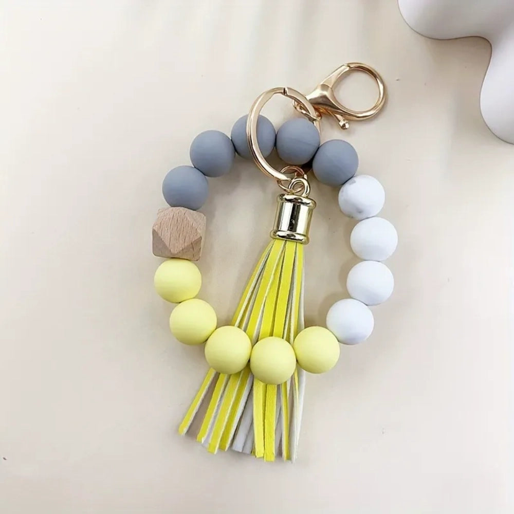 Set of 4 pastel silicone bead bracelet keychains with leather tassels in pink, blue, purple, and mint green, featuring marble and wood accent beads with gold lobster clasp hardware. - 7