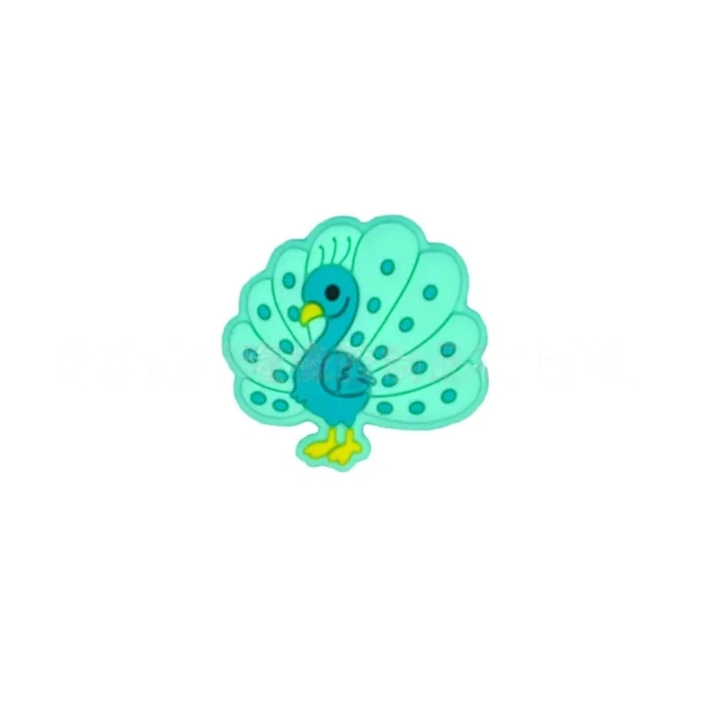 Five colorful peacock silicone focal beads in blue, mint green, olive green, pink, and purple displayed on a white ceramic dish against a teal background. - 5