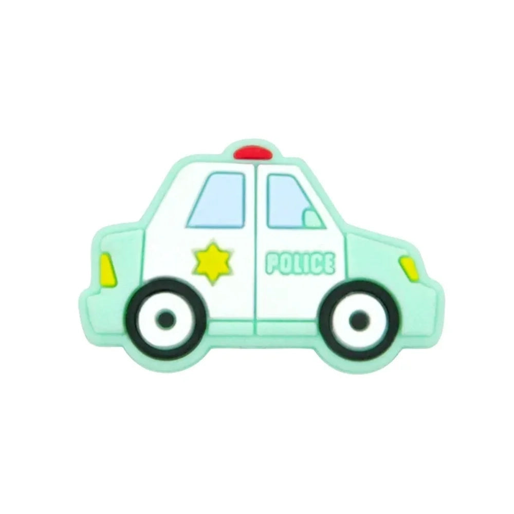 Six cartoon police car silicone focal beads in white, blue, black, mint green, light teal, and yellow displayed on a small wooden bench against a blue background, each featuring a gold sheriff star badge and POLICE text. - 1