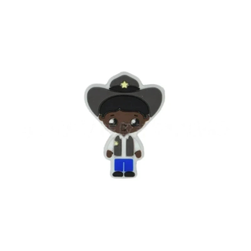 Assorted police girl silicone focal beads in multiple skin tones displayed on a white ceramic dish, featuring cute cartoon cop characters in blue uniforms with stars, perfect for beadable pens, keychains, and badge reels. - 1