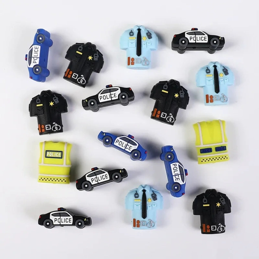 Assorted police-themed 3D silicone focal beads including black and white patrol cars, blue police cars, black police uniforms, light blue officer shirts, and yellow high-visibility police vests