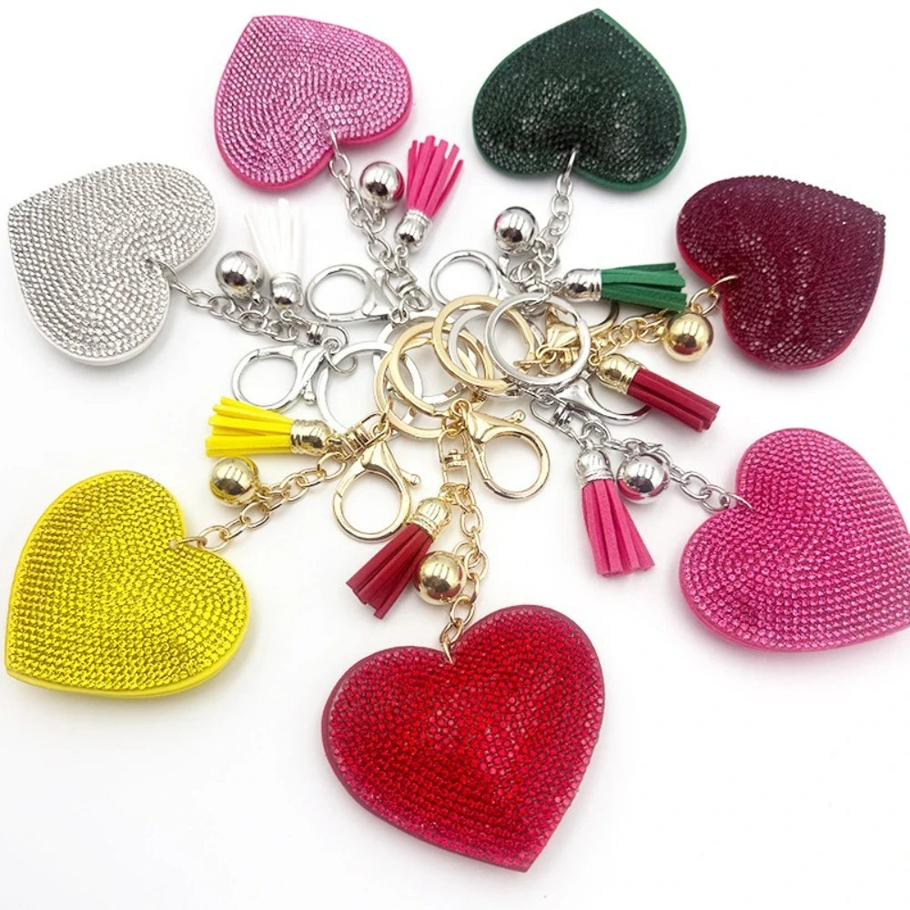 Assorted rhinestone crystal heart-shaped keychains with colorful tassels and lobster clasp in silver and gold tones, available in pink, red, green, yellow, silver, and magenta. - Random Mixed