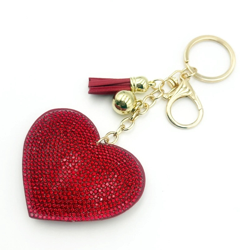 Assorted rhinestone crystal heart-shaped keychains with colorful tassels and lobster clasp in silver and gold tones, available in pink, red, green, yellow, silver, and magenta. - Red
