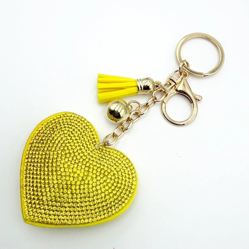 Assorted rhinestone crystal heart-shaped keychains with colorful tassels and lobster clasp in silver and gold tones, available in pink, red, green, yellow, silver, and magenta. - Yellow
