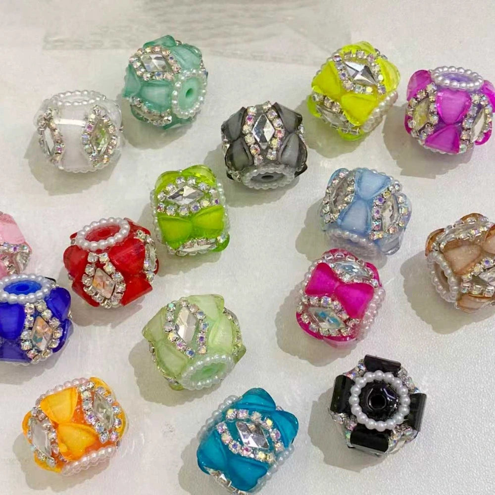 Assorted colorful resin cube fancy beads decorated with rhinestones, pearl trim, and bow details in multiple colors including teal, yellow, pink, red, blue, green, orange, and black for DIY jewelry making.
