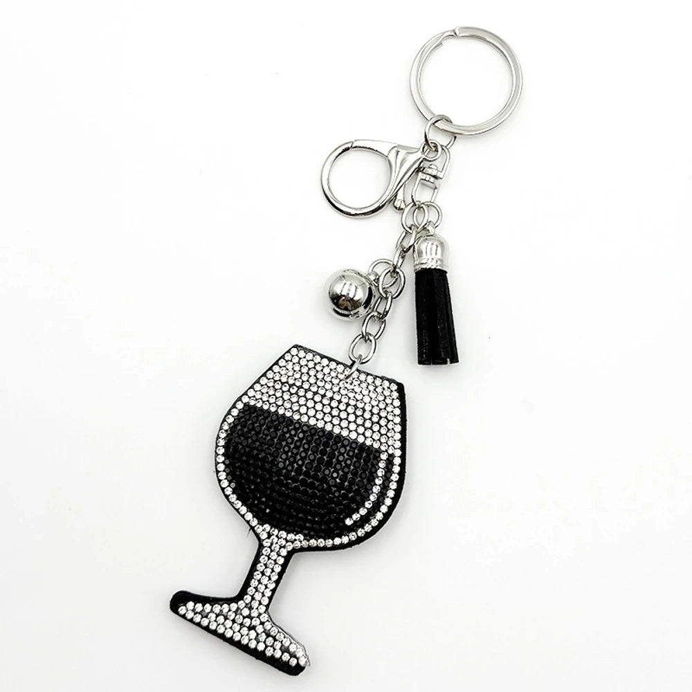 Four rhinestone-covered wine glass keychain charms in red, pink, blue, and black with matching tassels and silver bell accents on white background. - Black