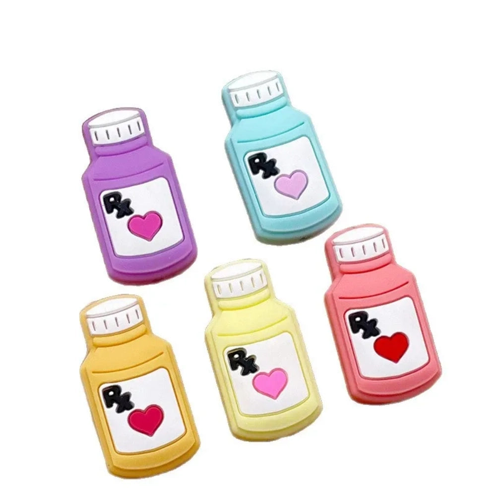 Five colorful silicone RX pill bottle focal beads in purple, teal, yellow, light yellow, and pink, each featuring a heart and RX label design, for DIY crafts and beadable pens. - Random Mixed