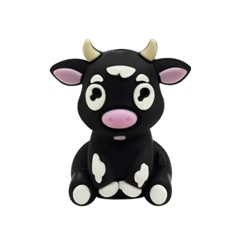 Set of 6 cute 3D baby cow silicone focal beads in white, tan, brown, and black color variants displayed on a miniature wooden bench against a yellow background. - Black