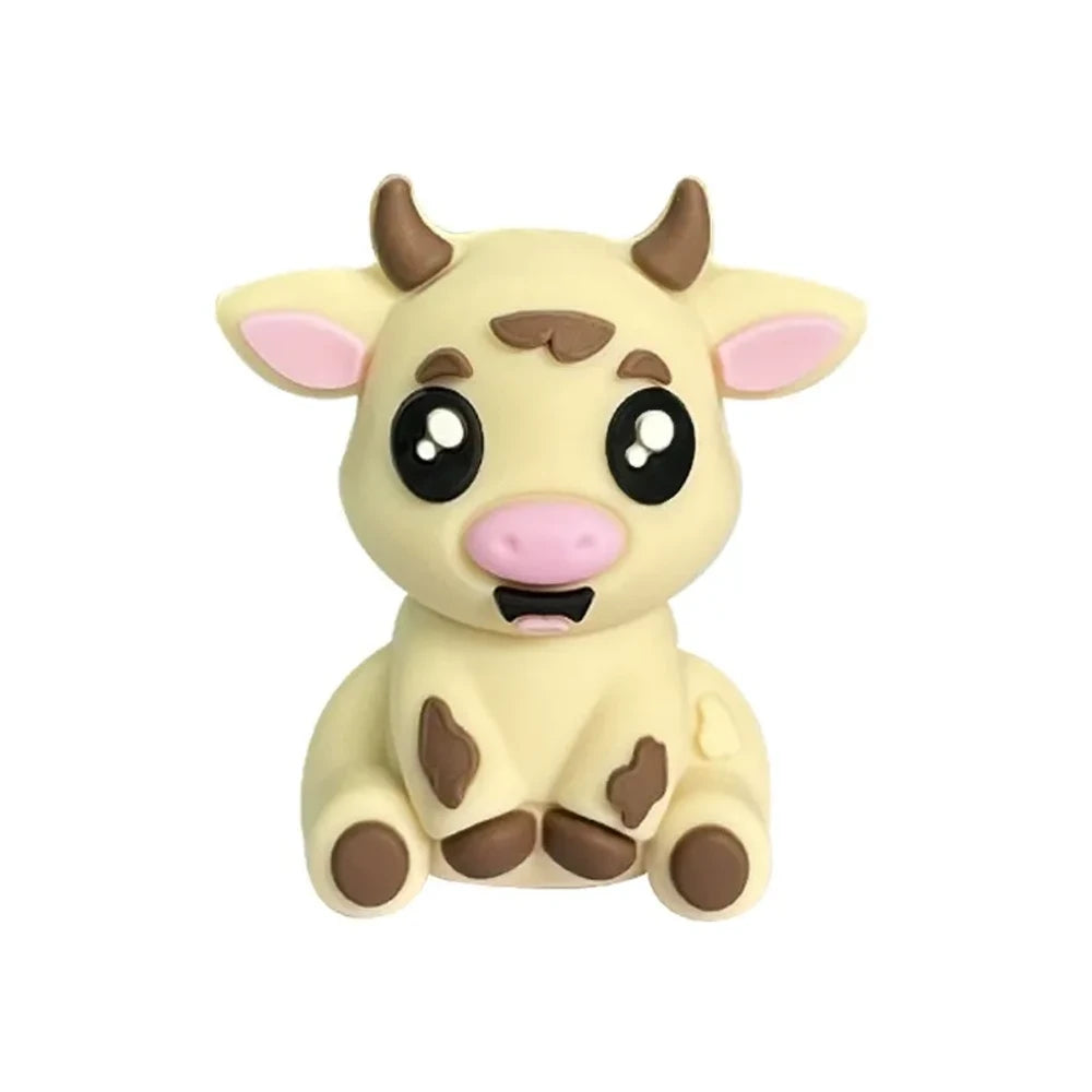 Set of 6 cute 3D baby cow silicone focal beads in white, tan, brown, and black color variants displayed on a miniature wooden bench against a yellow background. - Creamy White