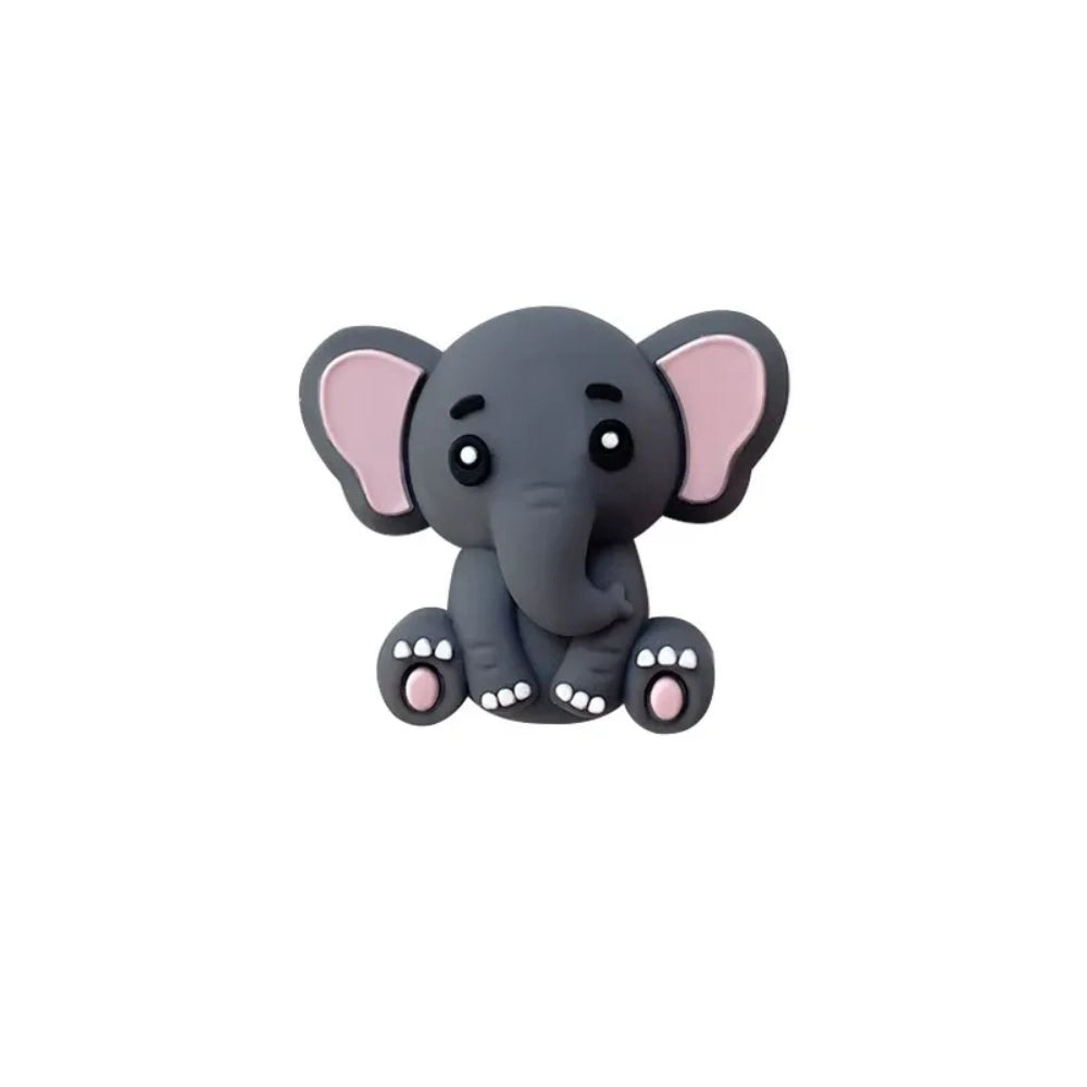 Five cute 3D baby elephant silicone focal beads in light gray, medium gray, dark gray, blue, and pink colors, sitting posed with pink inner ears and toenails, displayed on a white platform against a warm beige background. - Dark Gray