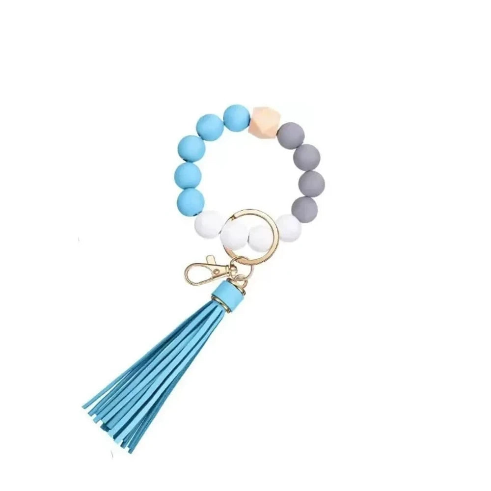 Set of 6 silicone bead wristlet keychains with colorful leather tassels in purple, blue, pink, gray, blush, and black on gold swivel clasps for DIY jewelry making. - 12