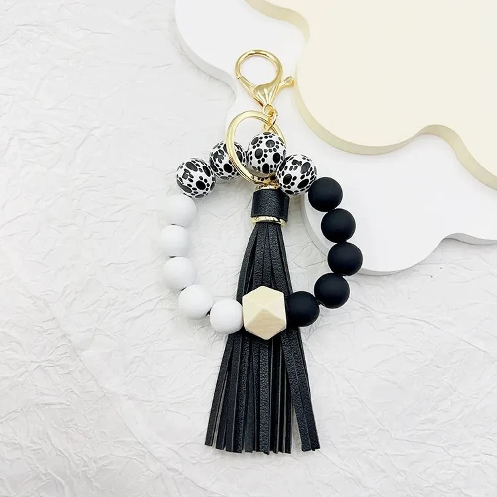 Set of 6 silicone bead wristlet keychains with colorful leather tassels in purple, blue, pink, gray, blush, and black on gold swivel clasps for DIY jewelry making. - 4