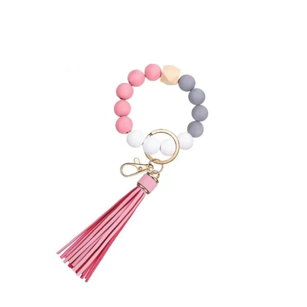 Set of 6 silicone bead wristlet keychains with colorful leather tassels in purple, blue, pink, gray, blush, and black on gold swivel clasps for DIY jewelry making. - 6