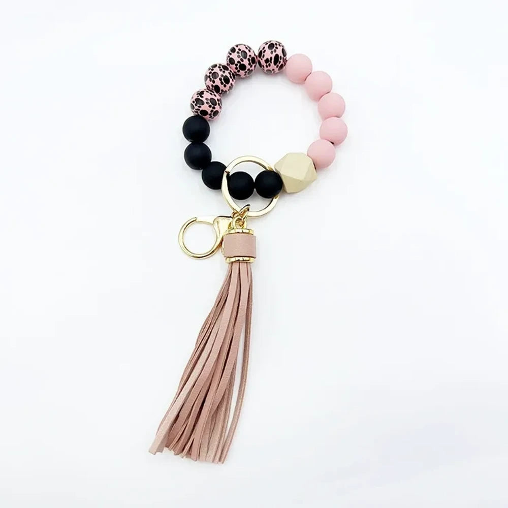 Set of 6 silicone bead wristlet keychains with colorful leather tassels in purple, blue, pink, gray, blush, and black on gold swivel clasps for DIY jewelry making. - 8