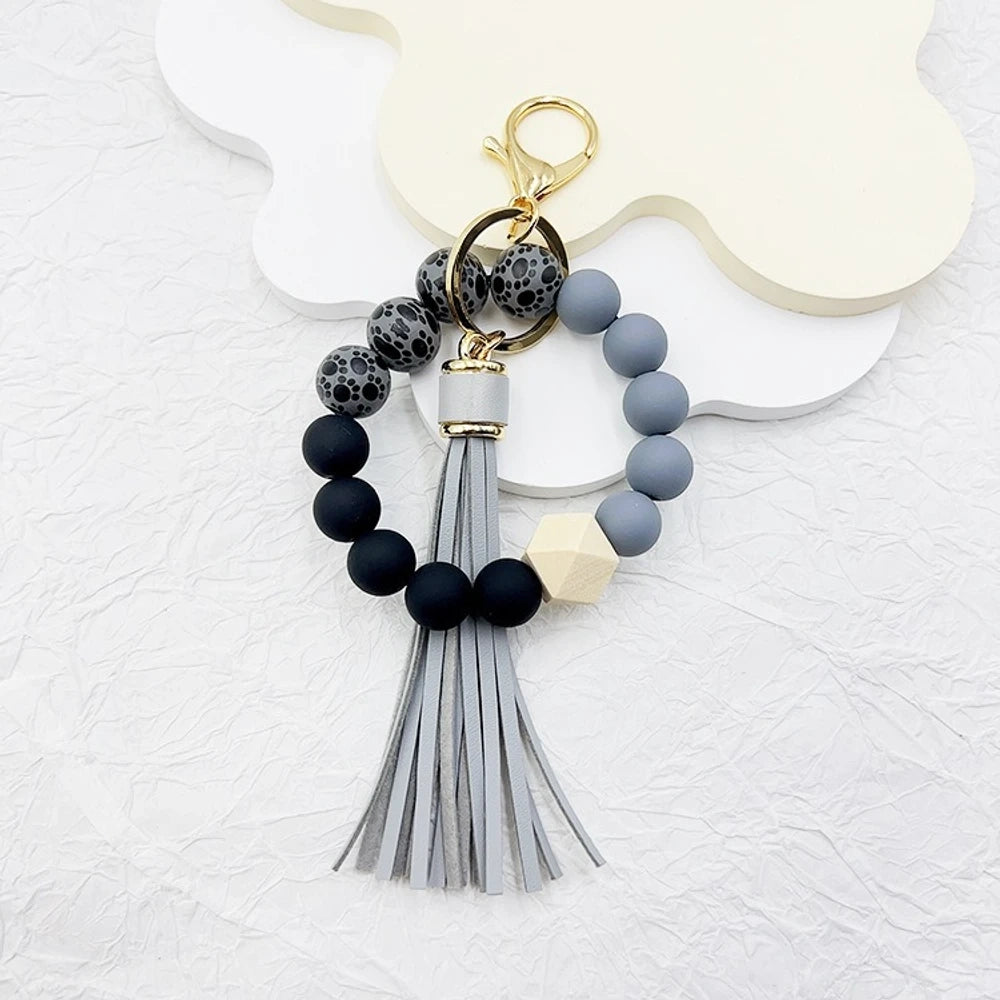 Set of 6 silicone bead wristlet keychains with colorful leather tassels in purple, blue, pink, gray, blush, and black on gold swivel clasps for DIY jewelry making. - 9