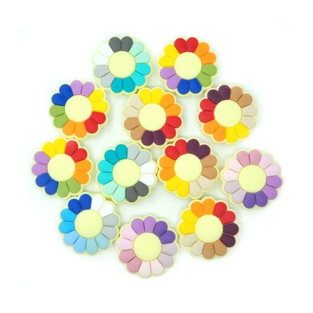 Assorted rainbow multi-color pinwheel flower silicone focal flatback beads with cream center, shown in multiple color combinations on white background.