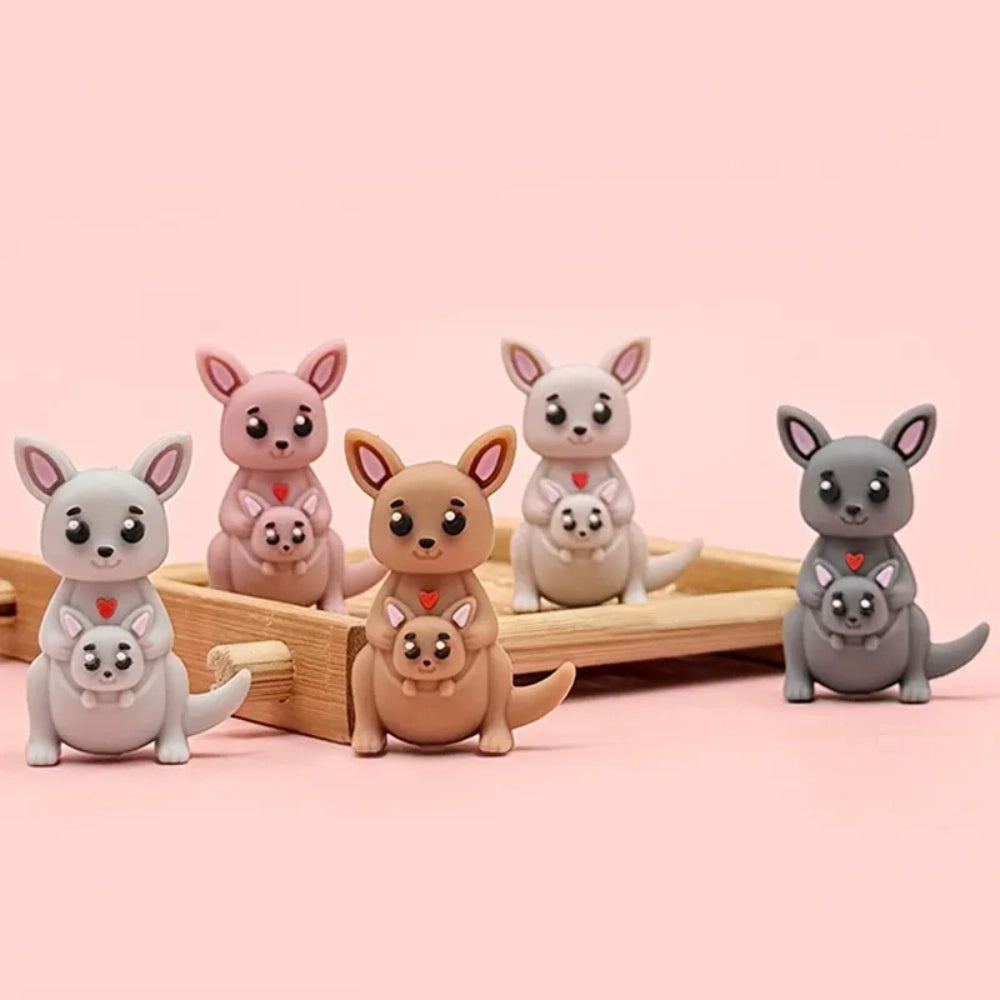 Set of 6 cute 3D kangaroo mother and joey silicone focal beads in gray, pink, tan, and dark gray colorways, displayed on a wooden tray with pink background. - Random Mixed