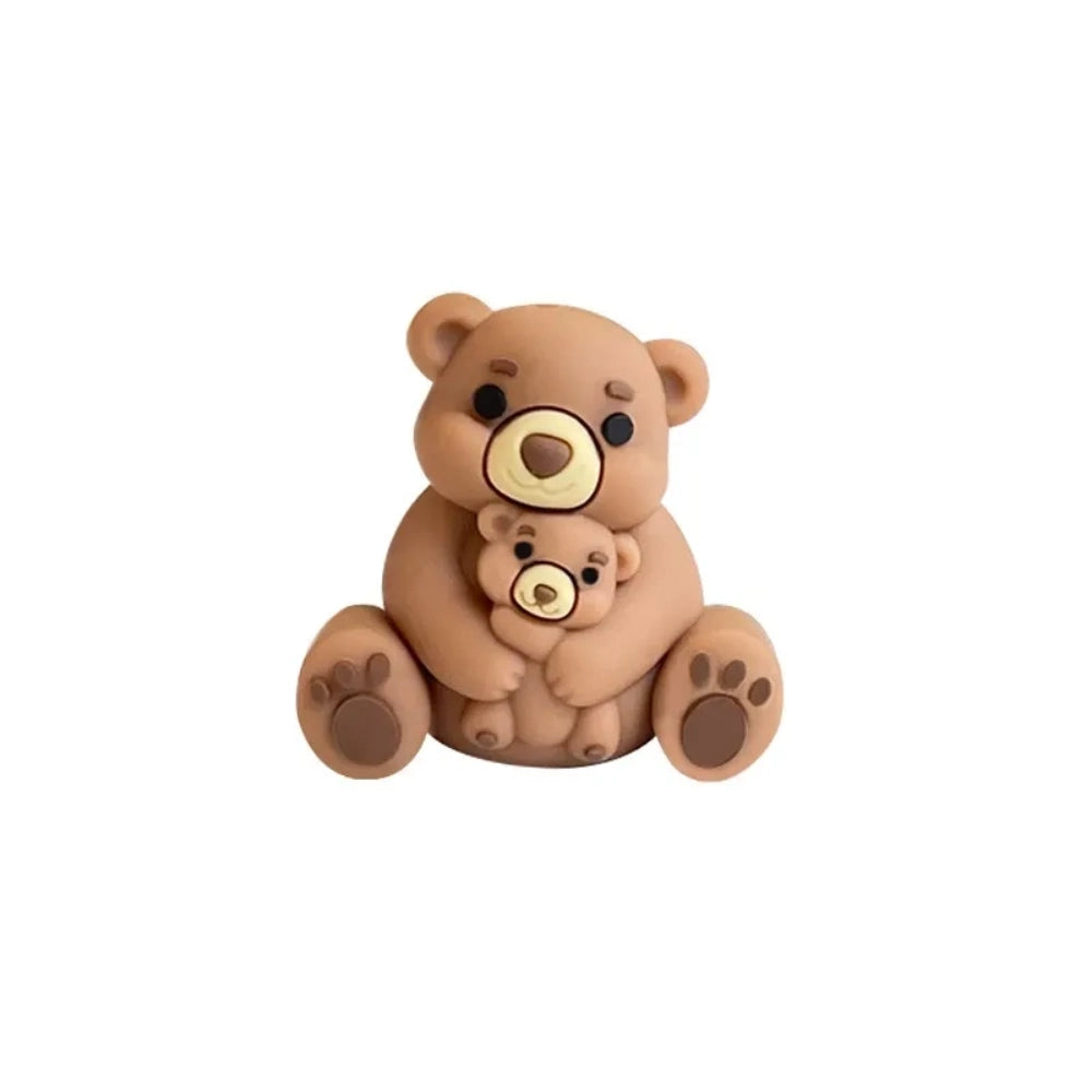 Six colorful 3D silicone focal beads shaped like a mama bear hugging a baby bear, available in gray, brown, yellow, pink, dusty pink, and blue, displayed on a white pedestal with a pink background. - 5