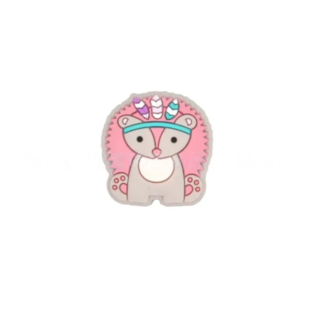 Five boho tribal animal silicone focal beads in pink, blue, yellow, brown, and gray featuring hedgehog, elephant, and lion characters wearing feathered headbands, displayed on a white background. - Pink