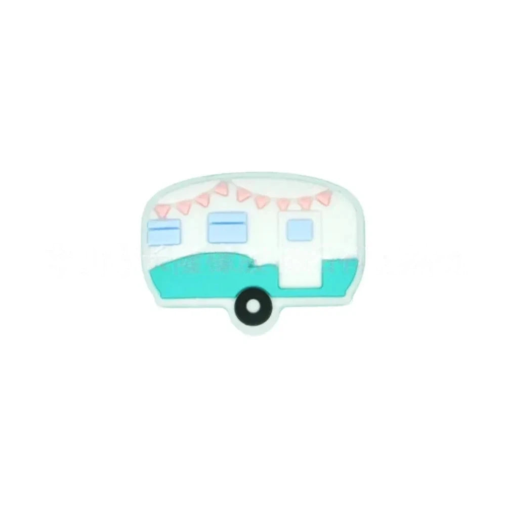 Four silicone camper trailer flatback focal beads in red, black, teal, and pink with bunting flag details on a teal background - Turquoise