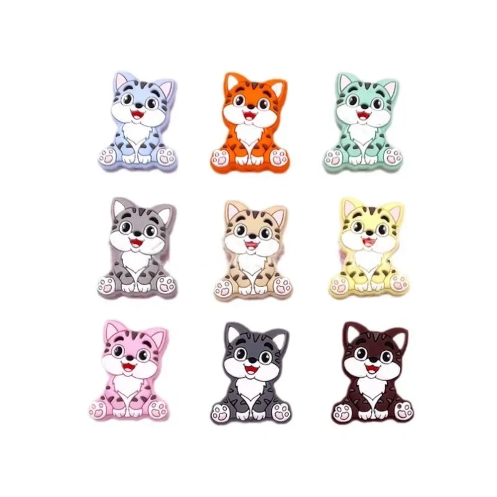 Nine colorful cartoon kitten cat silicone focal beads shown in blue, orange, mint, gray, tan, yellow, pink, dark gray, and brown on white background.