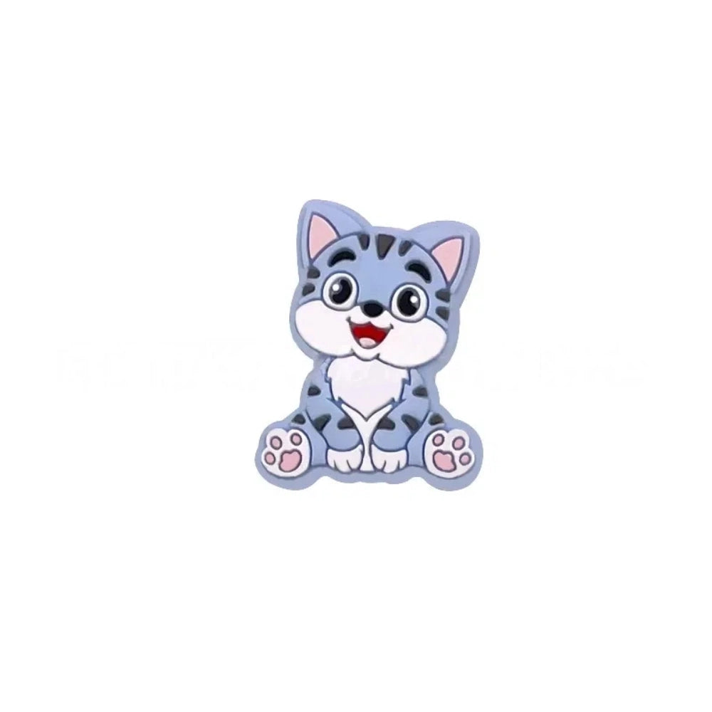 Nine colorful cartoon kitten cat silicone focal beads shown in blue, orange, mint, gray, tan, yellow, pink, dark gray, and brown on white background. - Blue
