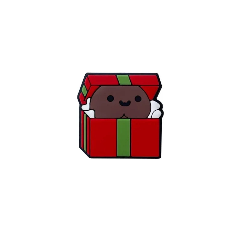Cute silicone focal beads shaped like red and green Christmas gift boxes with smiling character faces peeking out, shown in multiple skin tone variations on a wooden display tray. - 1