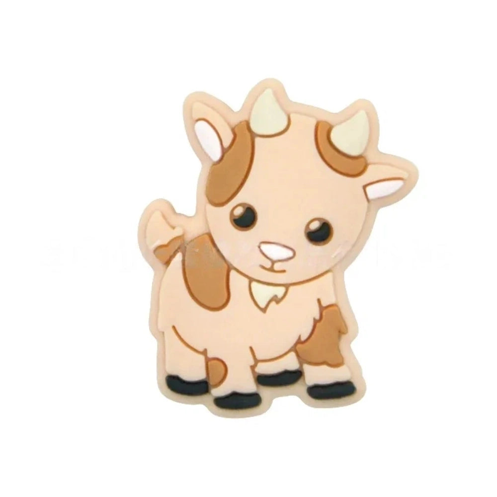 Assorted pastel color cute cow silicone focal beads displayed on a white shell dish and strung on a white cord against a teal background, available in gray, green, pink, tan, and white colorways. - Orange